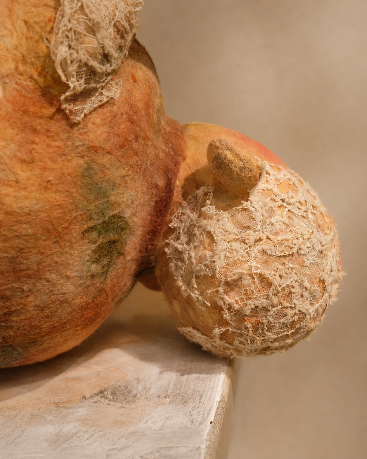 Side detail of Broken Jar's head and body, showing the creature's vessel-like form and damaged textile surface.