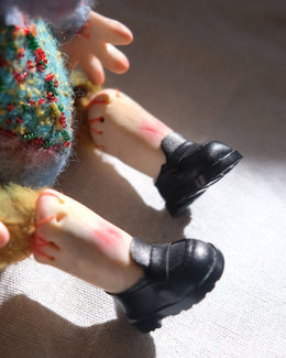 Side view of Dream Thief showing the five-jointed handmade doll structure.