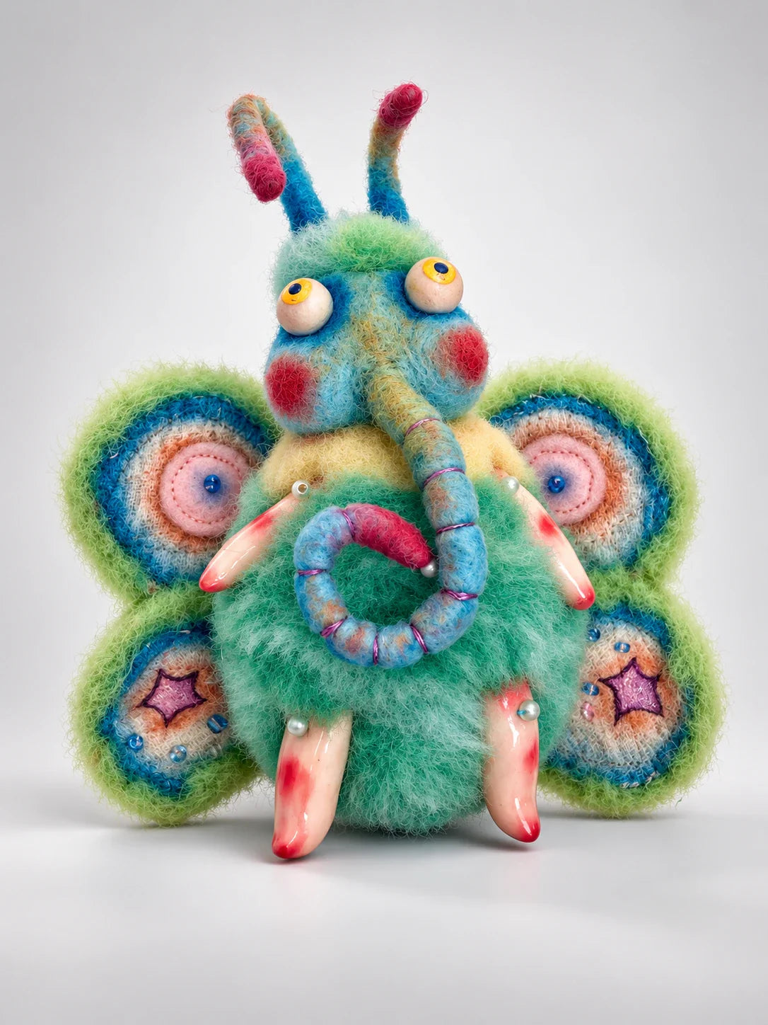 Dream Whisper, a handmade wool dream moth art doll with broad colorful wings, by artist Yujing Zhang.