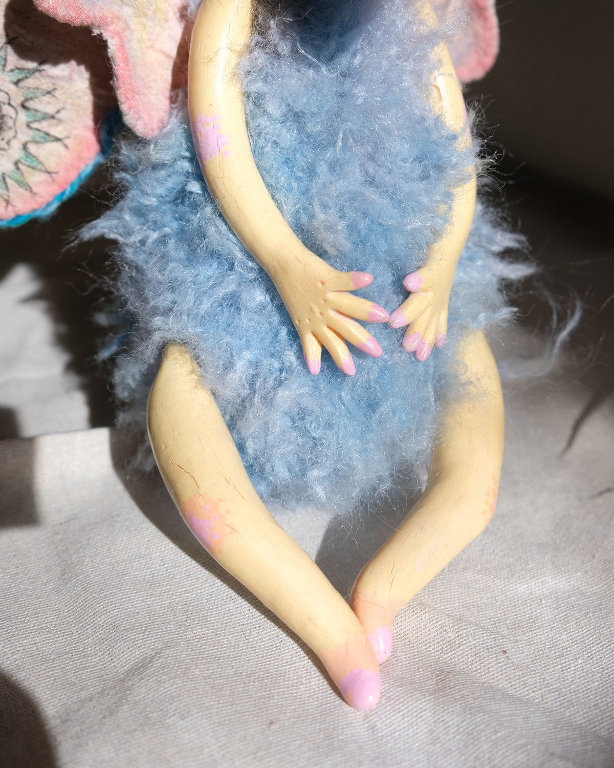 Detail of King Aster's small sculpted hand and delicate handmade surface.