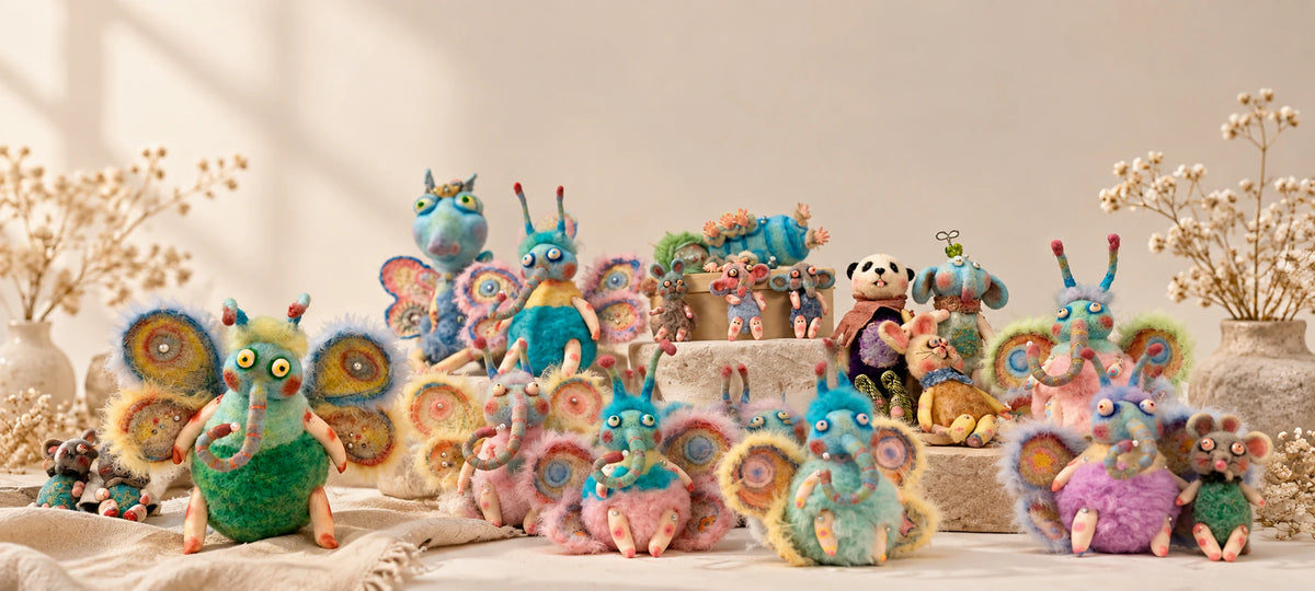 Luna Angel Studio's colorful character works arranged across a quiet studio tabletop.