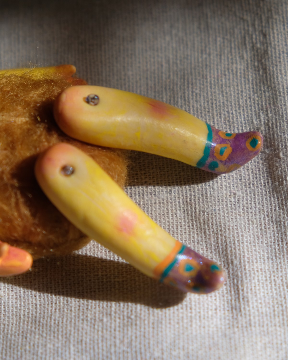 Leg detail of Tick Tock showing yellow sculpted legs, tiny screws, and painted purple shoes.